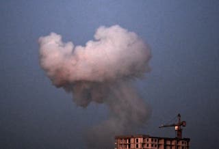 This picture shows smoke rising following an explosion during a night mass drone and missile strikes on Kyiv